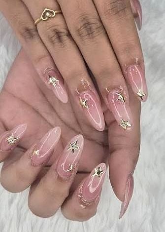 Nude-pink nails with delicate gold star accents